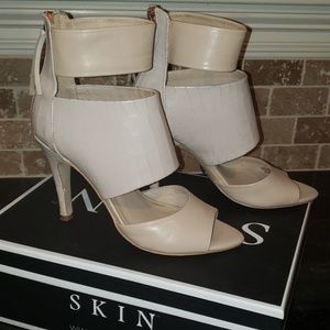 Nude reptile embossed leather pumps